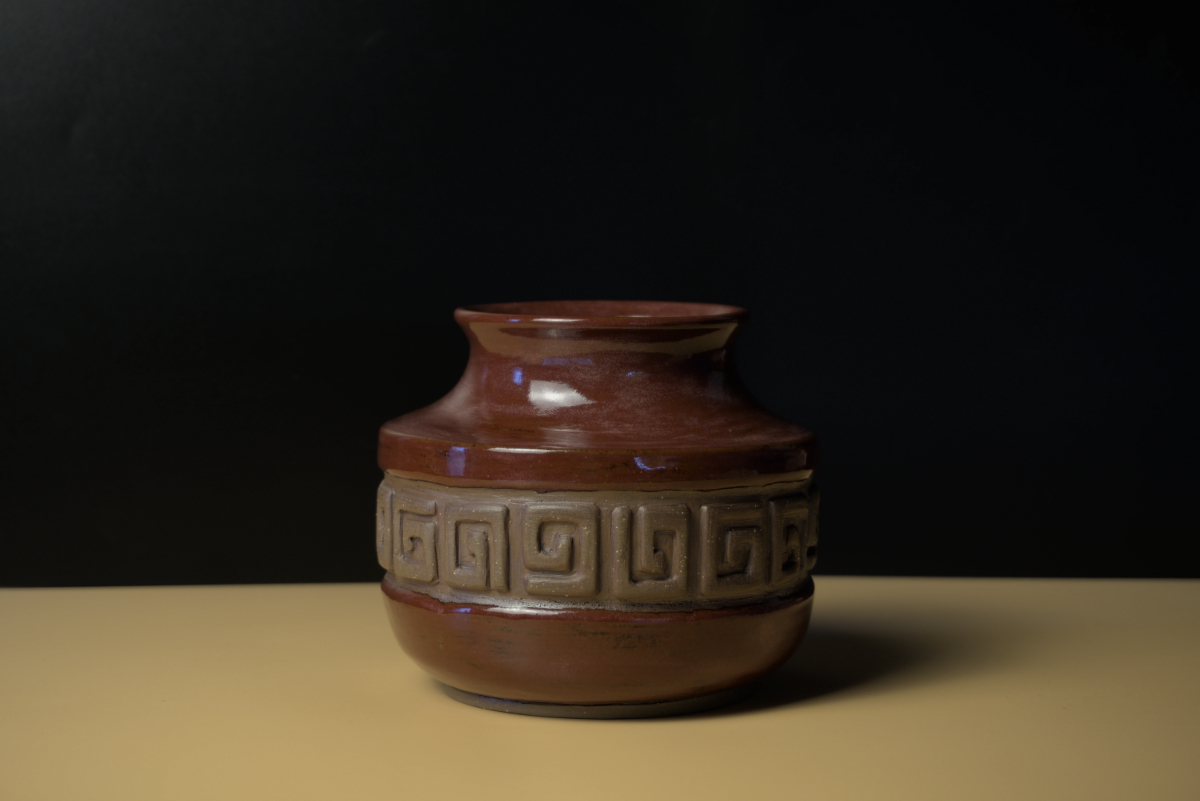 Pot with hand carved design